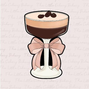 May include: A glass dessert cup with a brown and beige layered dessert topped with three coffee beans. The cup is on a white pedestal with a pink bow tied around it.
