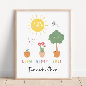 May include: A white background with a framed print that says "Let's Grow, Bloom, Root for each other". The print features a yellow sun, a bee, a green tree, a red flower, and a green sprout.