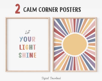 May include: Two framed posters with the text "CALM CORNER POSTERS". One poster reads "Let YOUR LIGHT SHINE" in colorful letters. The other poster features a sunburst design with a yellow center and colorful rays.