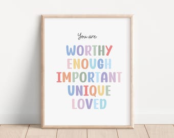 May include: A framed print with the text "You are WORTHY ENOUGH IMPORTANT UNIQUE LOVED" in a rainbow of colors. The text is in a playful, handwritten font.