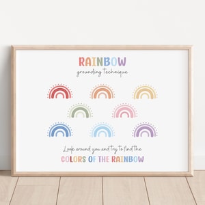 May include: A framed print with the text "RAINBOW grounding technique" and "Look around you and try to find the COLORS OF THE RAINBOW." The print features colorful rainbow illustrations in a variety of pastel colors.