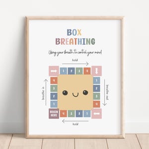 May include: A framed print with the words "BOX BREATHING" in colorful letters. The print illustrates a breathing exercise with a smiling face in the center and instructions for inhaling, holding, and exhaling. The text "Using your breath to control your mind" is also included.