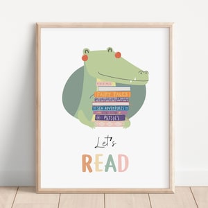 May include: A green alligator holding a stack of colorful books with the text "Let's Read" in rainbow colors.