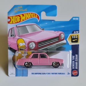 May include: A pink Hot Wheels die-cast toy car, The Simpsons Family Car, in its original blue blister packaging. The card features an illustration of Homer Simpson and the car, with text including The Simpsons, Hot Wheels, and Screen Time.