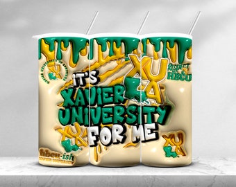 May include: Three white tumblers with green and yellow dripping paint designs. The tumblers feature the text "It's Xavier University for Me" and the Xavier University logo. The tumblers are on a white surface.