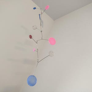 Kinetisches Mobile aus Epoxidharz & Edelstahl – Herz Skulptur zum Aufhängen TaJo Design weiß lila transparent Glitzer grün