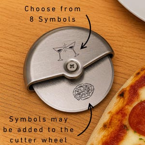 May include: A stainless steel pizza cutter with a round blade and a curved handle. The blade features etched designs of martini glasses and a pizza. Text on the image reads "Choose from 8 Symbols" and "Symbols may be added to the cutter wheel."