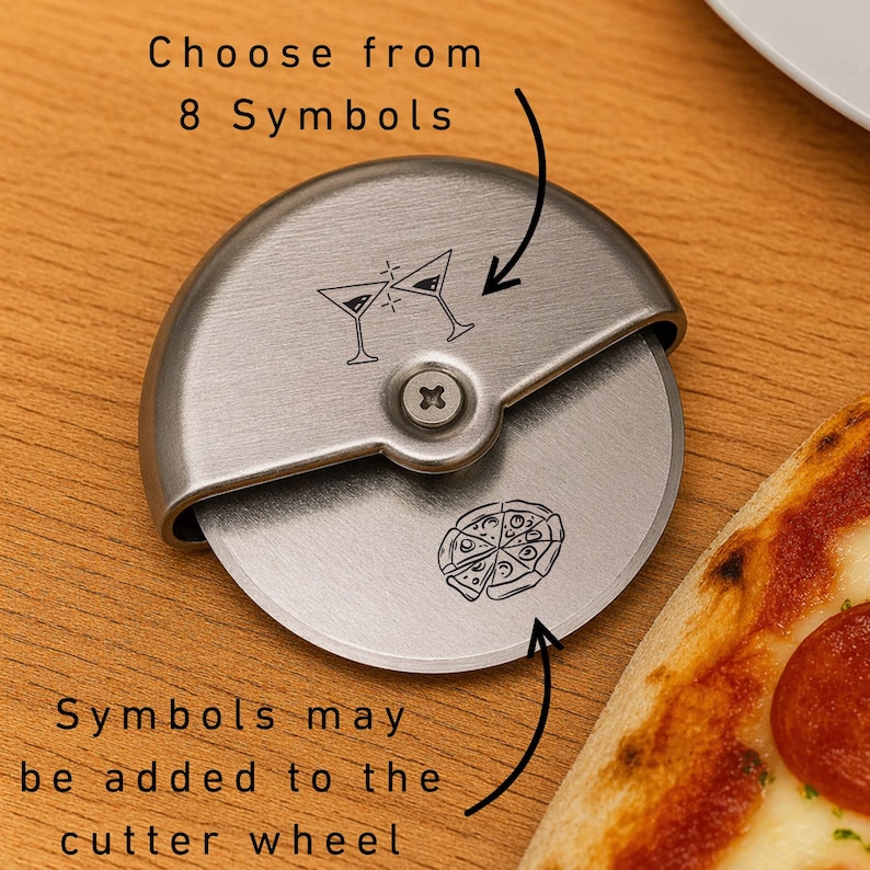 May include: A stainless steel pizza cutter with a round blade and a curved handle. The blade features etched designs of martini glasses and a pizza. Text on the image reads "Choose from 8 Symbols" and "Symbols may be added to the cutter wheel."