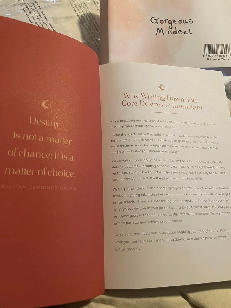 Pu&ograve; includere: Un libro aperto con una pagina sinistra rosso scuro che presenta il testo Destiny is not a matter of chance; it is a matter of choice di William Jennings Bryan. La pagina destra &egrave; bianca con il titolo Why Writing Down Your Core Desires is Important.
