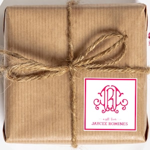 May include: A brown paper package tied with twine and a pink square sticker. The sticker has a pink monogram with the initials "JR" and the text "a gift from JAYCEE ROMINES".