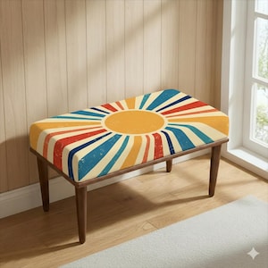May include: A retro-style bench with a vibrant sunburst design. The seat features a large yellow sun with radiating stripes in red, blue, and cream. The bench has a dark brown wooden frame and legs, adding a touch of warmth to the design.