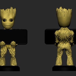 Könnte beinhalten: Eine goldene Groot-Figur, die einen schwarzen Smartphone-Ständer hält. Die Figur ist detailliert mit strukturierter Rinde und einem kleinen, topfförmigen Sockel.