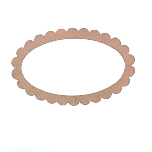 May include: A brown scalloped oval frame made of wood.