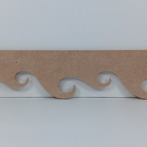 May include: A wooden trim with a wavy design, perfect for adding a decorative touch to any project.