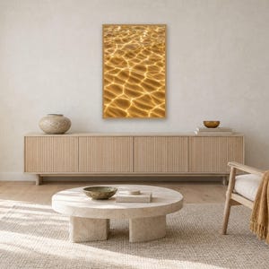 May include: A rectangular wall art print featuring a high-angle view of golden sunlight reflecting on clear water, creating a network of bright, shimmering light patterns across a warm, amber-toned surface with deep golden highlights.