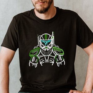 May include: Black t-shirt with a green, white, and grey graphic of a futuristic soldier's helmet and armour. The design has a neon outline. The shirt is short-sleeved and made of a soft material.