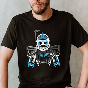 Puede incluir: Una camiseta negra con un gráfico blanco y azul de un soldado clon de Star Wars.