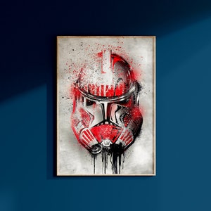May include: A red and black Star Wars Stormtrooper helmet with white paint splatters on a grey background.