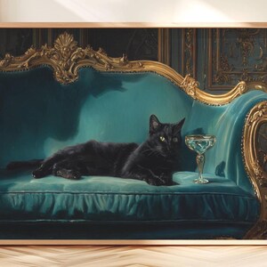 May include: A framed print of a black cat lounging on a teal velvet sofa with ornate gold trim. A champagne glass sits nearby. The artwork has a vintage, regal aesthetic.