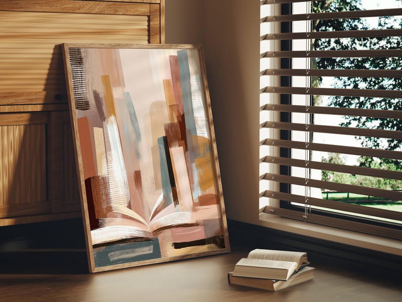 May include: Abstract art print in a wooden frame. The artwork features a colorful composition of vertical brushstrokes in shades of brown, beige, and blue, with an open book at the bottom. The print is leaning against a wooden cabinet.