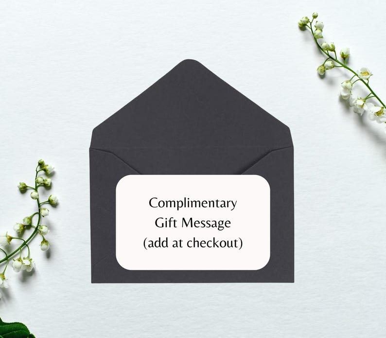 May include: A dark gray envelope with a white rectangle on the front that says "Complimentary Gift Message (add at checkout)"