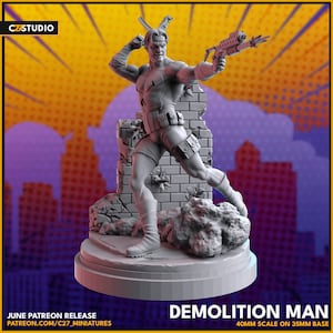 May include: A grey 3D printed miniature of a superhero figure holding a gun and standing on a brick wall base. The figure is wearing a black and white costume with a red star on the chest. The base is 35mm and the figure is 40mm scale. The figure is titled "Demolition Man".