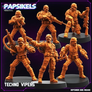 Puede incluir: Figuras de acción Techno Vipers de color naranja, cada una posando con armas, se exhiben sobre bases negras. Las figuras llevan cascos y equipo táctico. El texto "PAPSIKELS" y "TECHNO VIPERS" es visible.