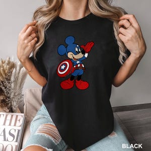 a woman wearing a mickey mouse t - shirt