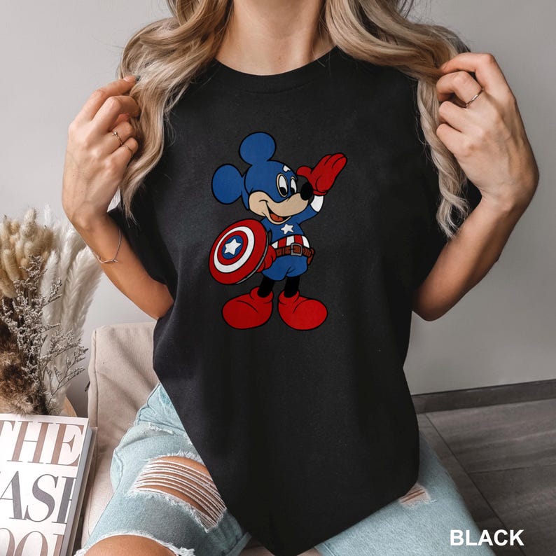 a woman wearing a mickey mouse t - shirt