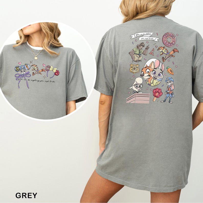 May include: Grey t-shirt with cartoon illustrations and text on the front and back. The front displays a mouse character with a bow and text. The back features multiple cartoon characters and the text "THE BIG DONUT".
