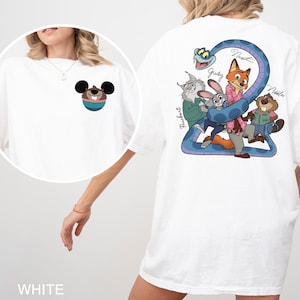 May include: White t-shirt featuring a cartoon graphic on the front and back. The front graphic is a Mickey Mouse-inspired character. The back graphic features cartoon characters and the text "Judy", "Nick", and "Nibbles".