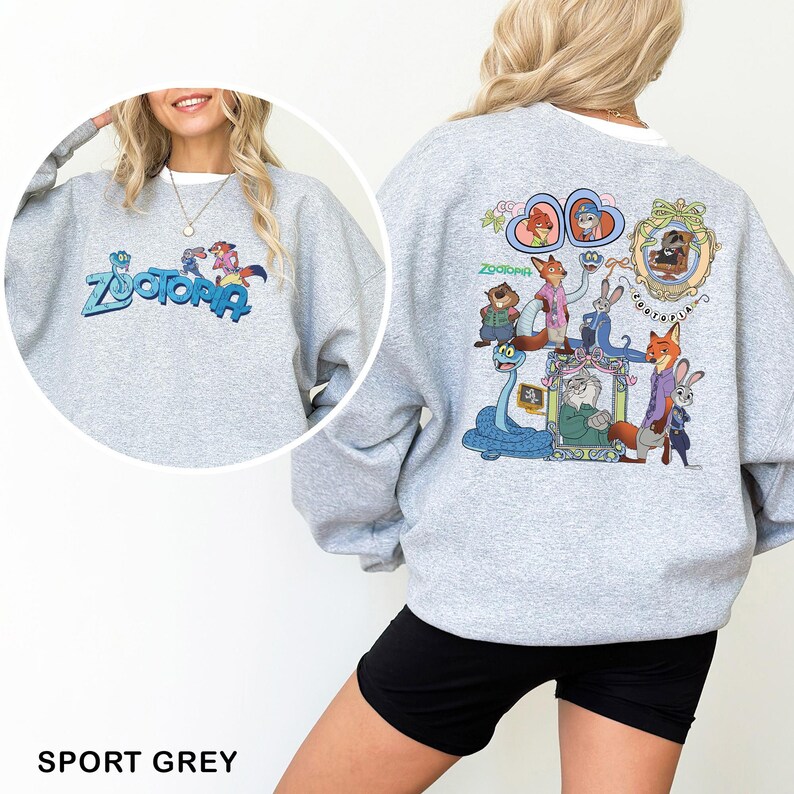 Puede incluir: Sudadera gris deportiva con la palabra "Zootopia" en azul y un gr&aacute;fico de dibujos animados en la parte delantera. La parte trasera de la sudadera tiene un gr&aacute;fico colorido de personajes de la pel&iacute;cula "Zootopia".