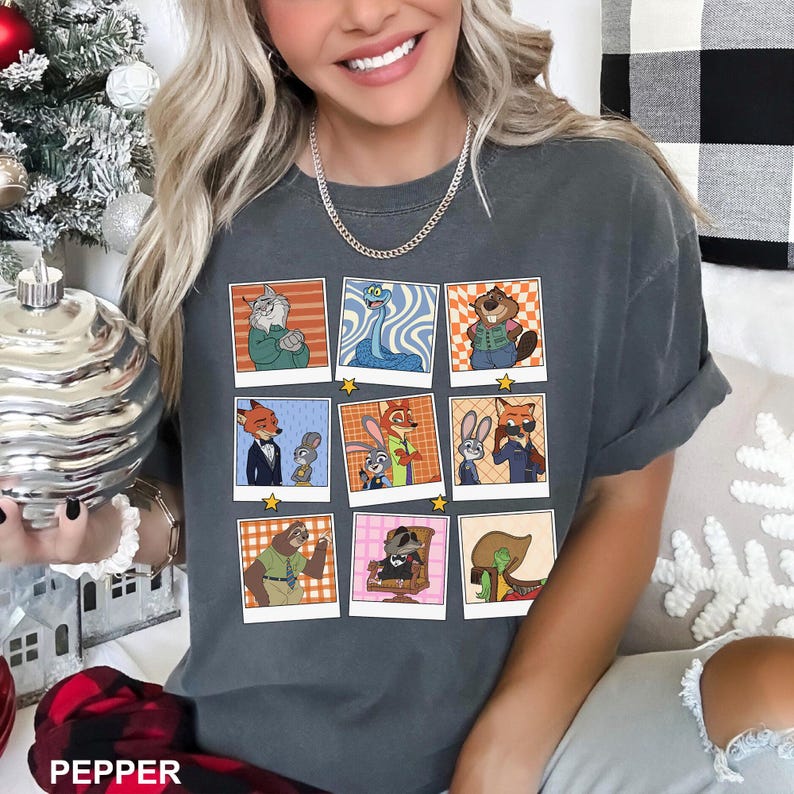 May include: Dark gray t-shirt featuring a grid of nine cartoon character images in a retro style. The images are in a polaroid style with a yellow star in the corner. The word "PEPPER" is printed at the bottom of the image.