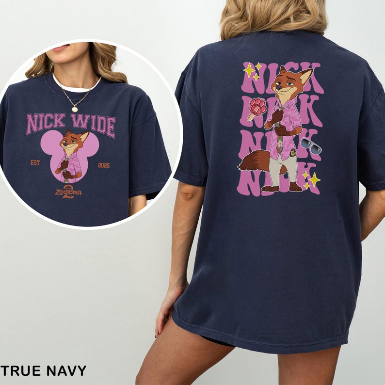 May include: True navy blue t-shirt with a cartoon fox character in a pink shirt and sunglasses. The front of the shirt has the text "NICK WIDE" and a cartoon fox image. The back of the shirt has the text "NICK" repeated vertically.