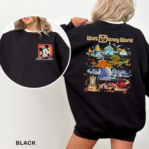 May include: Black sweatshirt featuring a Mickey Mouse graphic on the front and a colorful Walt Disney World design on the back. The front graphic includes the text "Magic Kingdom Since 1971". The sweatshirt has a white collar.