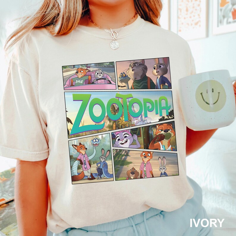 K&ouml;nnte beinhalten: Ein cremefarbenes Kurzarm-T-Shirt mit einem mehrteiligen Grafikdruck aus dem Film Zoomania. Das Design zeigt verschiedene Szenen mit den Charakteren Nick Wilde und Judy Hopps sowie den gro&szlig;en gr&uuml;nen Zoomania-Filmlogo-Schriftzug.
