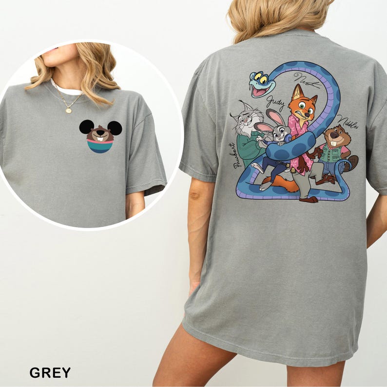 May include: Grey t-shirt featuring a cartoon design on the front and back. The front has a cartoon character's face. The back has a blue snake with cartoon characters. The word "GREY" is at the bottom of the shirt.
