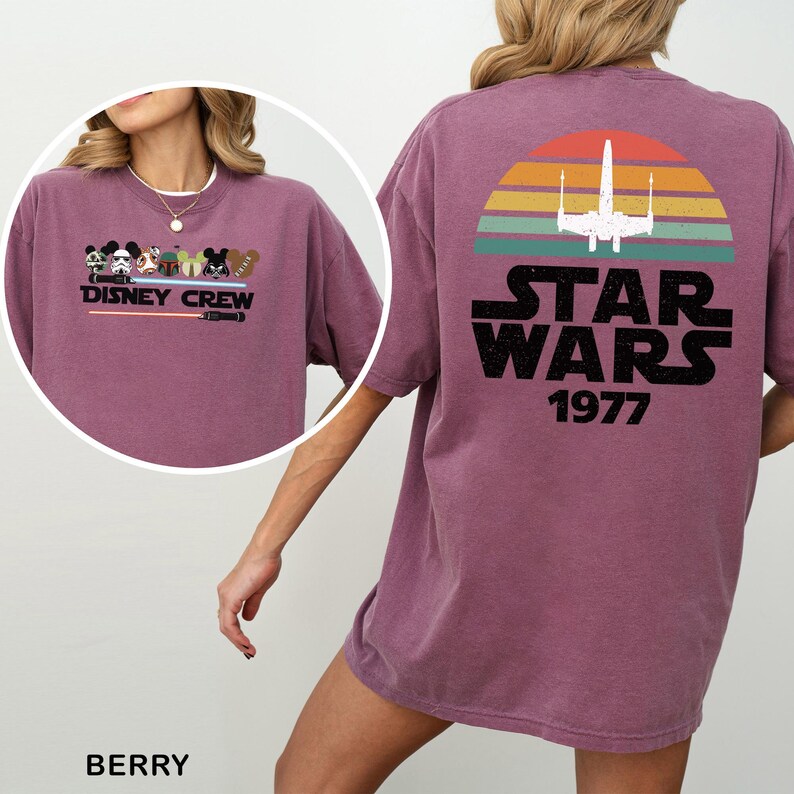 May include: Berry-coloured t-shirt with a Disney Crew graphic on the front and a Star Wars design on the back. The Star Wars graphic includes an X-wing fighter, a sunset design, and the text "STAR WARS 1977."