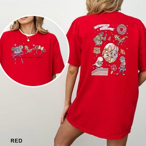 May include: Red t-shirt with cartoon characters and text. The front has a circular design with cartoon characters and the text "...for anything your heart to be". The back has a larger design with more cartoon characters and the text "THE BIG DONUT".