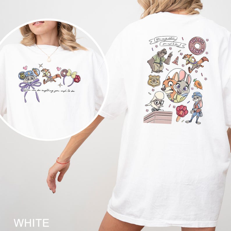 May include: White t-shirt with a cartoon graphic on the front and back. The front graphic includes character ears and the text "You can be anything you wish to be." The back graphic features cartoon characters and the text "The Big Donut."