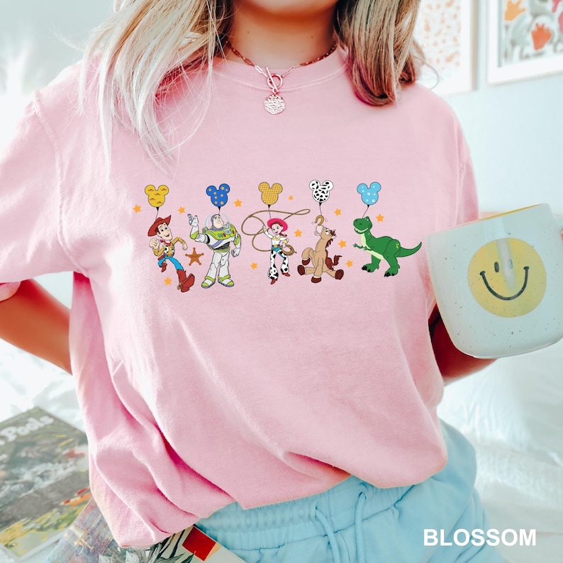 a woman in a pink shirt holding a coffee mug