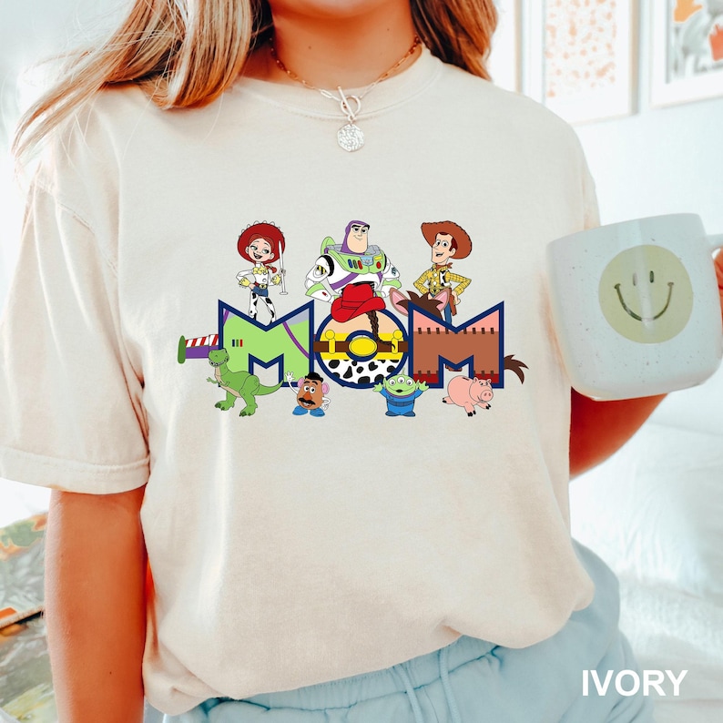 a woman wearing a t - shirt with cartoon characters on it