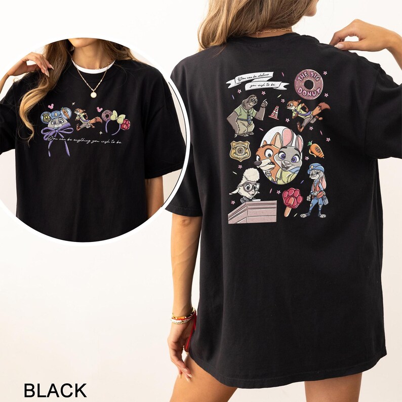 May include: Black t-shirt with cartoon characters and the phrase "You can be anything you wish to be." The back of the shirt features more cartoon graphics and the words "The Big Donut."