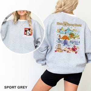 May include: Sport grey sweatshirt featuring a Mickey Mouse graphic on the front and a colorful Walt Disney World map design on the back. The sweatshirt has long sleeves and a crew neck. The text "Walt Disney World" is printed on the back.