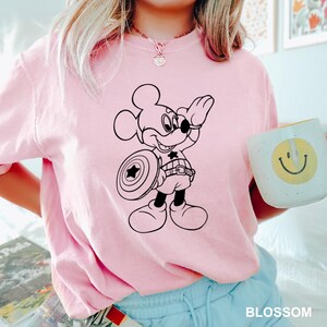 a woman in a pink shirt holding a coffee mug