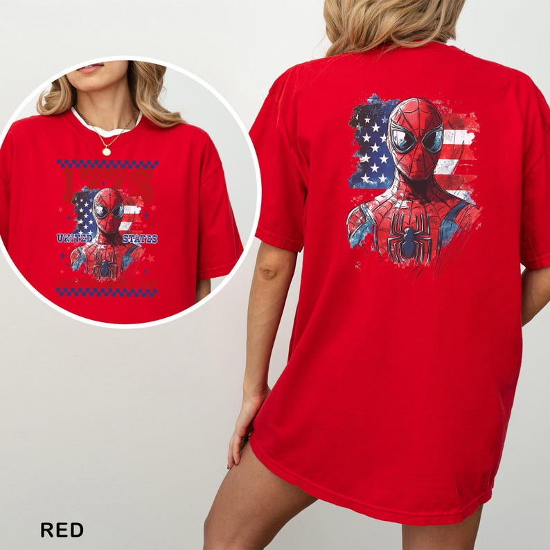 May include: A bright red t-shirt featuring a graphic of the superhero Spider-Man centered over a stylized American flag. The design includes the text UNITED STATES. The back of the shirt displays a larger version of the same graphic print.