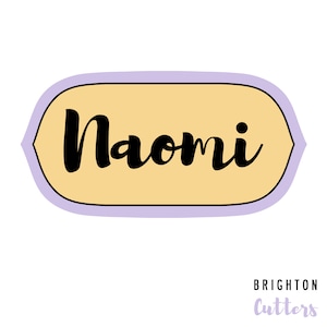 May include: A light purple and yellow label with a black cursive font that reads "Naomi" and the text "BRIGHTON Cutters" in a smaller font below.
