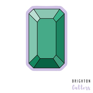 May include: A green emerald gemstone sticker with a white outline and a light purple background. The sticker says "Brighton Cutters" in purple text.