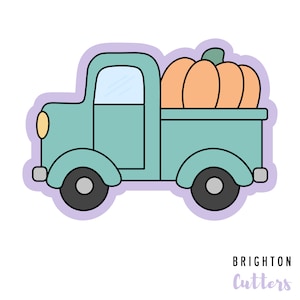 May include: A teal blue vintage truck with a pumpkin in the bed. The truck has a white cab and black wheels. The pumpkin is orange with a green stem. The image is a cookie cutter design.
