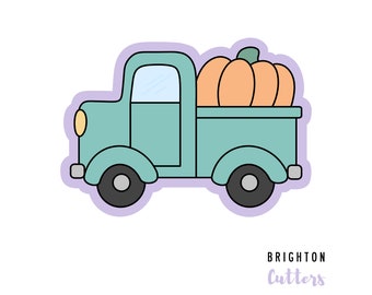 May include: A teal truck cookie cutter with a light purple outline, featuring a large orange pumpkin in the truck bed, a yellow headlight, and grey wheels. The text BRIGHTON CUTTERS is printed in black and purple in the bottom right corner.